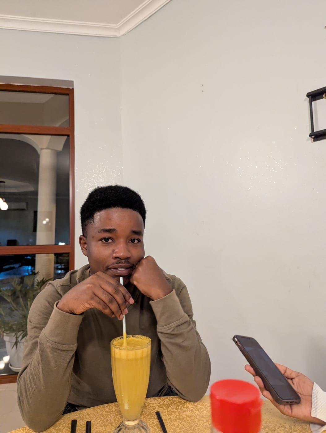 Emmanuel at a restaurant table