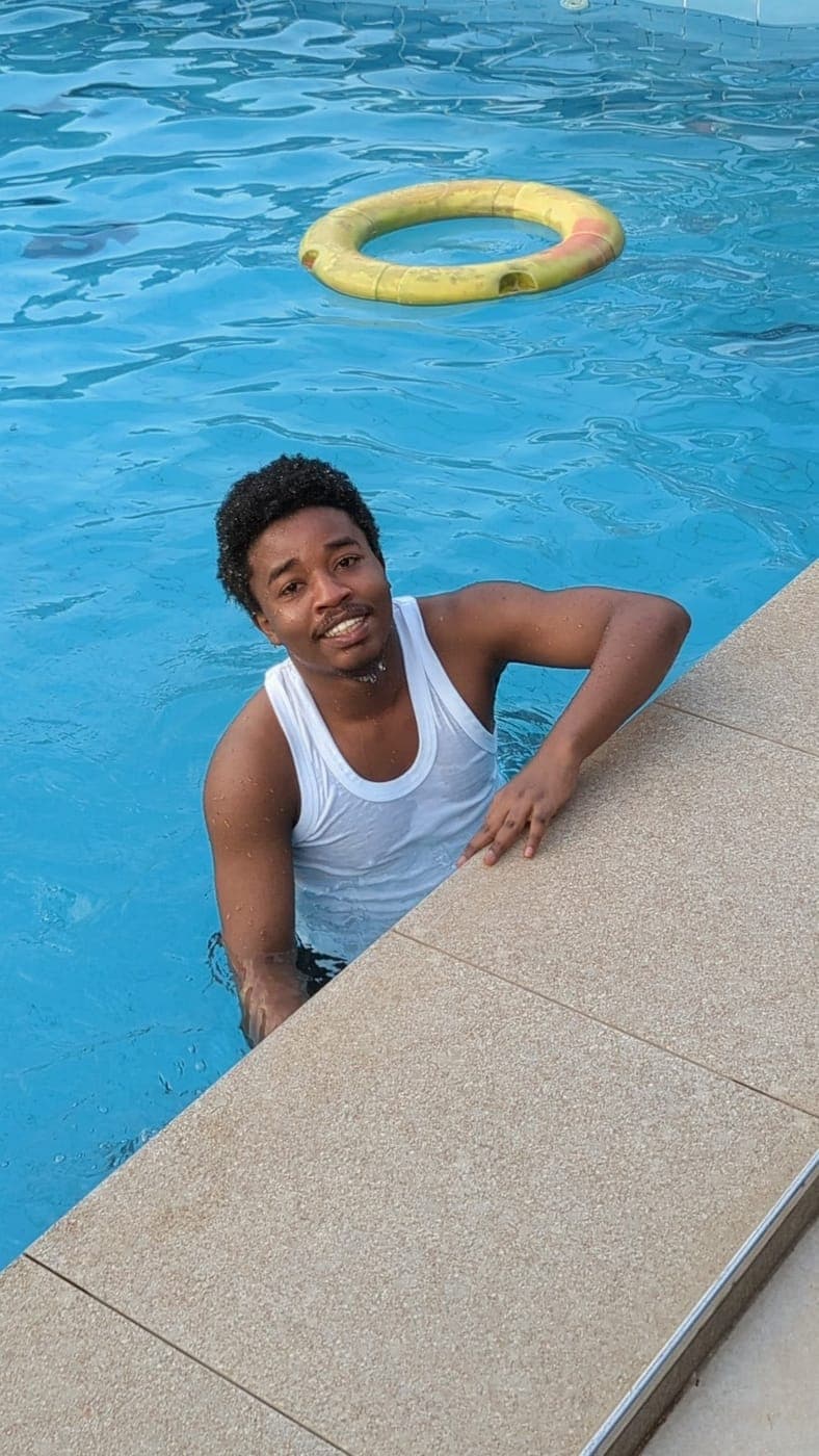 Emmanuel at the edge of a swimming pool