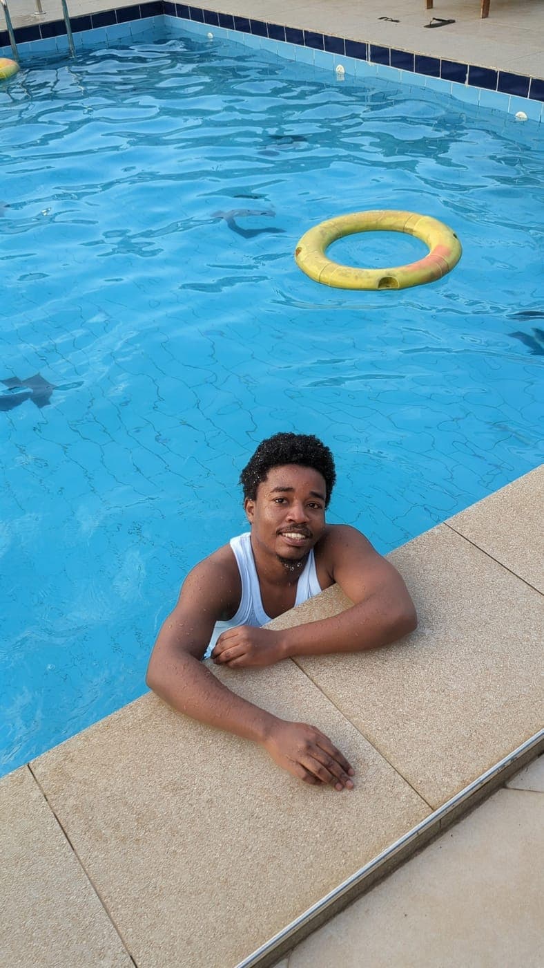 Emmanuel at the edge of a swimming pool