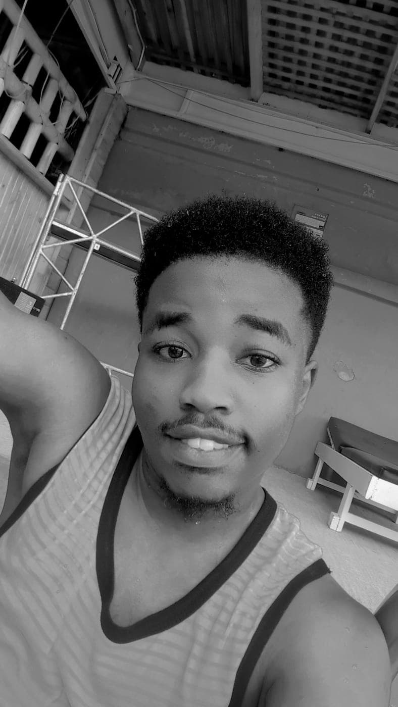 Black-and-white portrait of Emmanuel outdoors