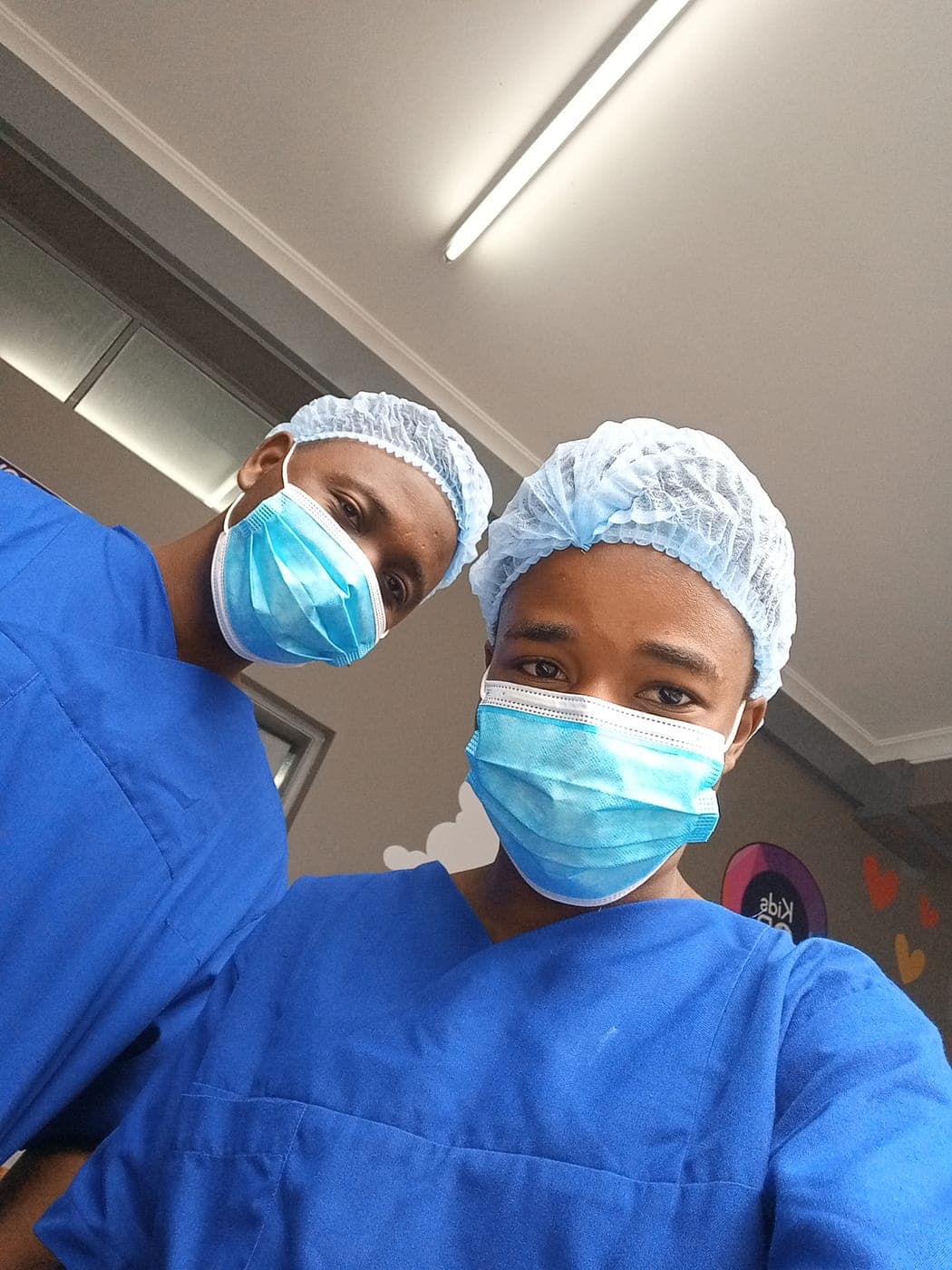 Emmanuel in theatre scrubs and surgical cap