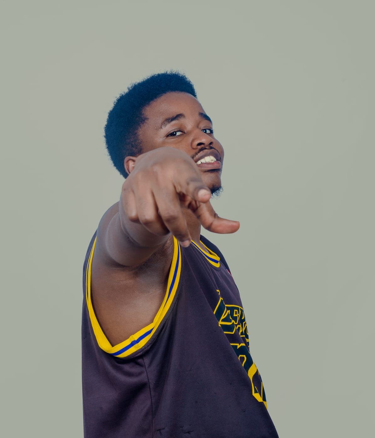 Emmanuel pointing playfully at the camera during a photo shoot